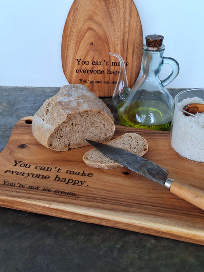 Egg shaped cutting board displayed with a big cutting board and food