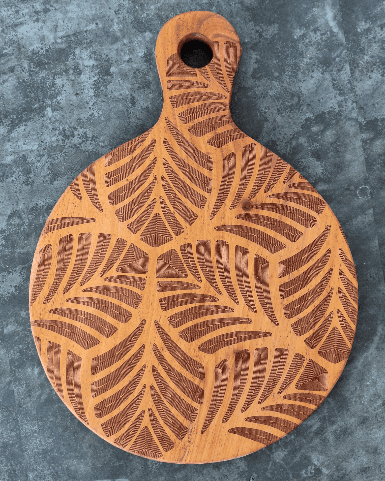 Tiny paddle shaped cutting board with tropical leaves laser engraved
