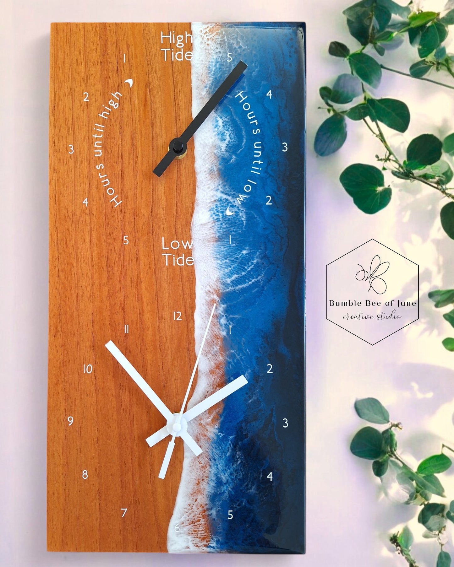 Rectangular double clock with a tide clock and a rectangular clock, diplayed with eucalyptus leaves, light and shadows