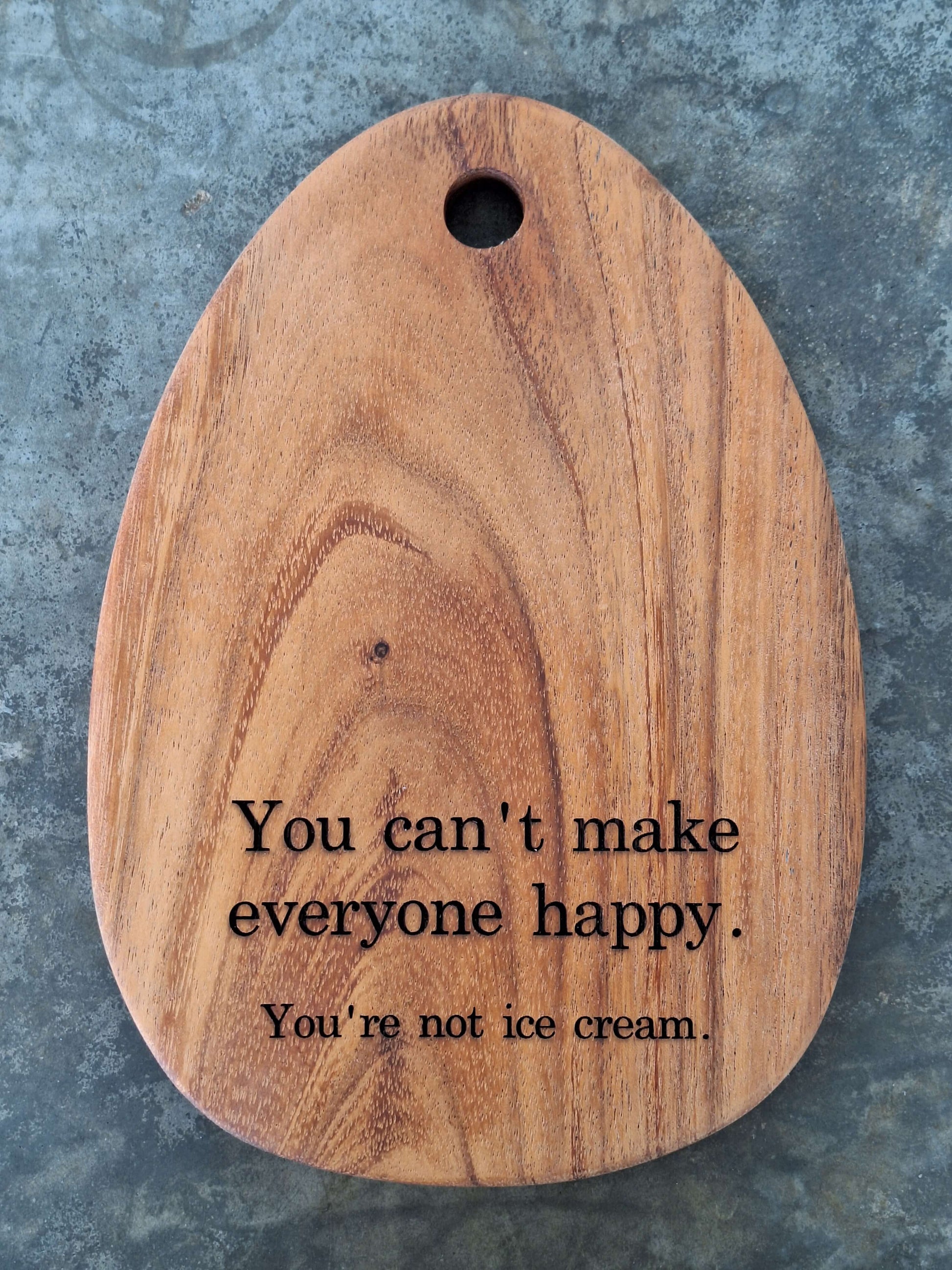Egg shaped tiny cutting board engraved with the humor quote "you cannot make everyone happy, you are not ice cream"