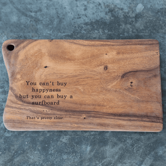 Large Wooden cutting board with the humor quote : "you cannot buy happiness but you can buy a surfboard. That's pretty close"