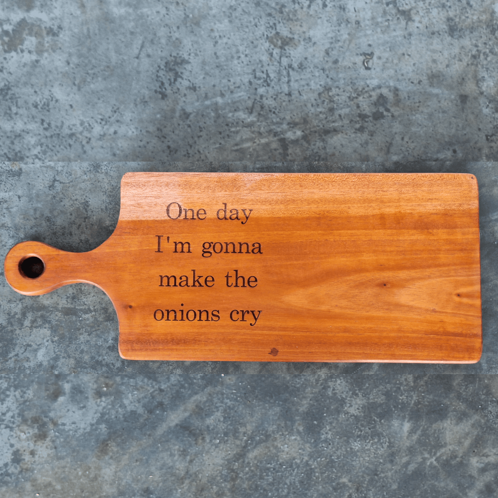 Cutting board with the humor quote "One day I'm gonna make the onions cry"